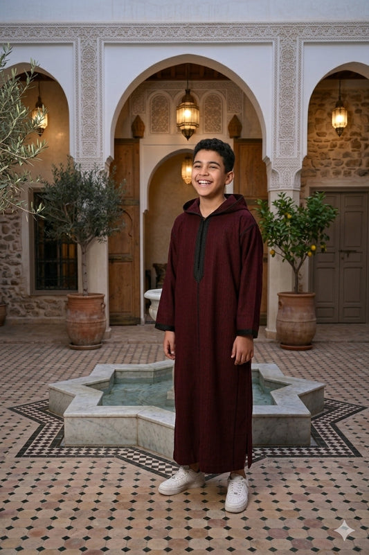 Kids winter Djellaba from Al-Andalus, cozy traditional Moroccan garment in warm fabric, with intricate patterns and a hood.