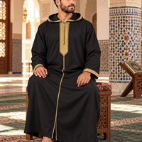Black and Gold Soft Jellaba worn seated inside a Moroccan mosque