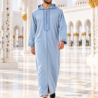 Light Blue Soft Jellaba worn walking through a white mosque courtyard